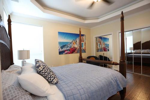 a bedroom with a bed and a chair in it at Stay by Kemah Boardwalk- Diamond Retreat in Kemah