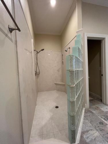 a bathroom with a shower and a tile floor at Stay by Kemah Boardwalk- Diamond Retreat in Kemah