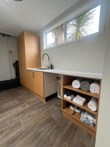 a kitchen with a sink and a counter with towels at Ocean Breeze Retreat in Kaka Point