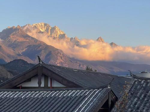 a view of a mountain range with a building at One Zen Lodge Snowy Haven in Lijiang