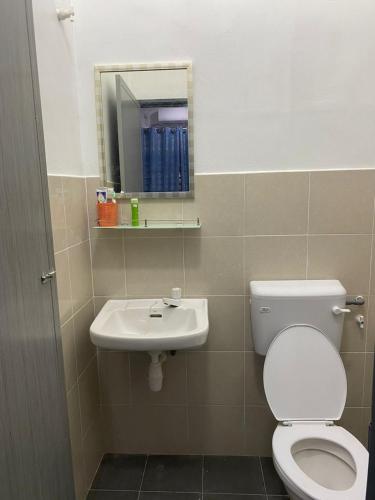 a bathroom with a toilet and a sink at Ainun Homestay with private pool in Kuantan