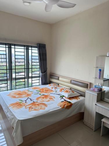 a bedroom with a large bed with orange flowers on it at OUG Parklane Block A1 in Kuala Lumpur