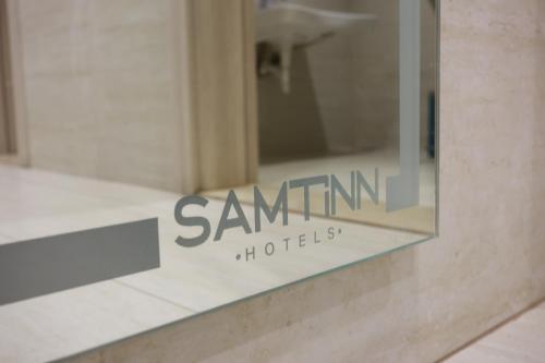 a sign on the side of a building at Samtinn Hotel King Fahad in Riyadh