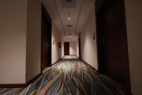 a corridor in a building with a colorful carpet on the floor at Samtinn Hotel King Fahad in Riyadh
