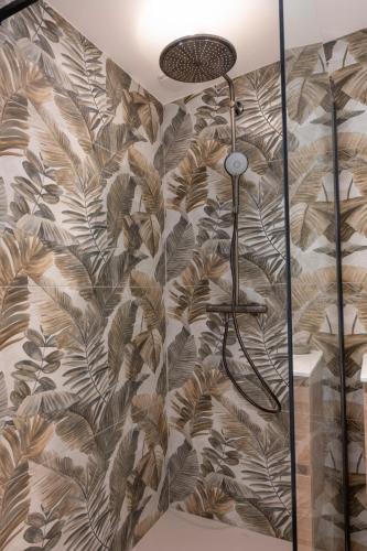 une salle de bain avec un papier peint marron et blanc dans l'établissement Noscia Nivaledda - Stone house, with pool, à Porto-Vecchio