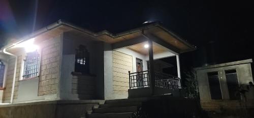a small house with a porch at night at Aberdare Home Two Bedroom in Othaya