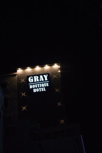 a sign that says gray bounce house at night at Gray hotel in Tongyeong