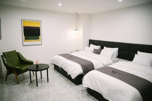 a hotel room with two beds and a table at Gray hotel in Tongyeong