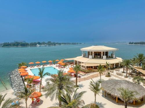 an aerial view of a resort with a swimming pool at Peaceful and Airy 1-bedroom Apartment with the Palm beach view in Dubai