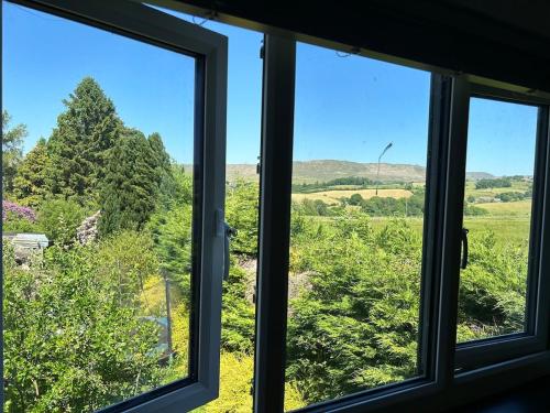 a window with a view of a field at The Studio at Pinethwaite in Kendal