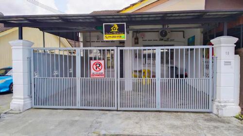 a white gate in front of a house at Orchid Homestay Pasir Gudang in Pasir Gudang