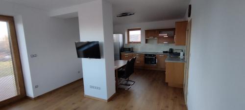 a kitchen with a desk and a television in it at Residence Lhotka - Žďárské vrchy in Lhotka