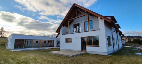 a white house with a gambrel roof at Residence Lhotka - Žďárské vrchy in Lhotka