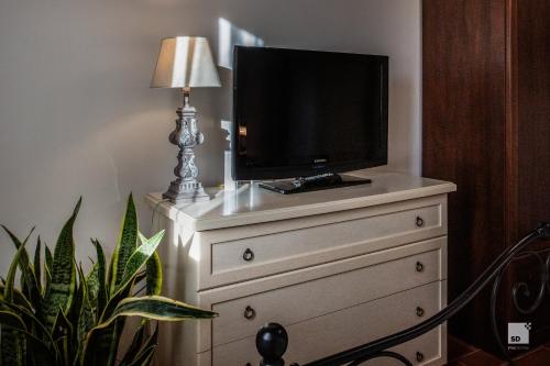 a television on top of a dresser in a room at Tenuta Il Burchio in Incisa in Valdarno