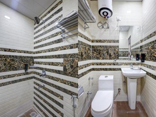 a bathroom with a toilet and a sink at Hotel Warm Welcome Inn - Noida Sector 26 in Noida