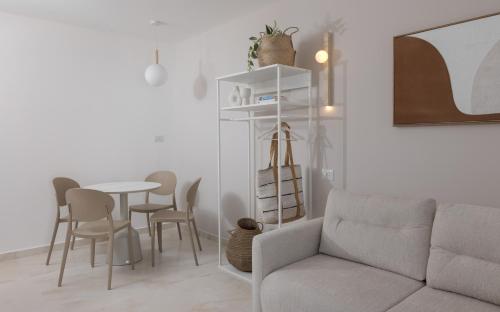 a living room with a couch and a table at אורה דירות אירוח -נץ 9- דירות נופש איכותיות לנופש שקט ואקסלוסיבי in Eilat
