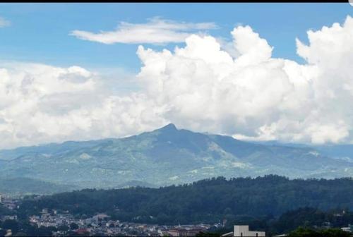 a view of a mountain with clouds in the sky at Kandyan View Holiday Bungalow'' FREE PICKUP FROM KANDY CITY'' in Kandy