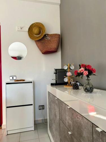 a kitchen with a counter with flowers on it at Apartment - Solarium in San Nicola Arcella
