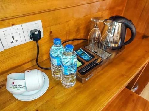 a counter with two bottles of water and a blender at Kandyan View Holiday Bungalow'' FREE PICKUP FROM KANDY CITY'' in Kandy