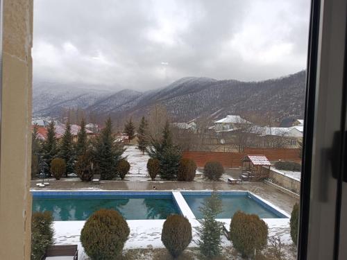 a view of a swimming pool with mountains in the background at Gabala Bliss Inn Hotel and Restaurant in Gabala