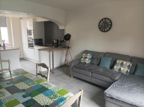 un salon avec un canapé et une table dans l'établissement A l'ombre du Lilas - avec Spa privatif en supplément, à Épinal