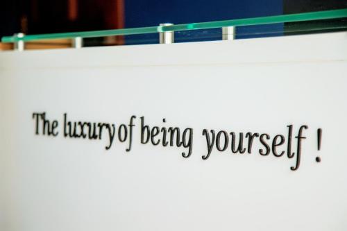 a sign that reads the library of being yourself at Blue Berries Hotel in Entebbe