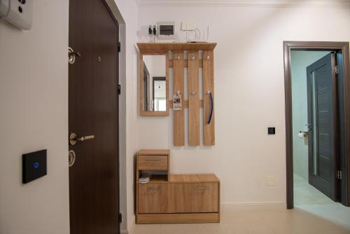 a room with a mirror and a wooden cabinet and a door at ByaResidence in Valea Lupului