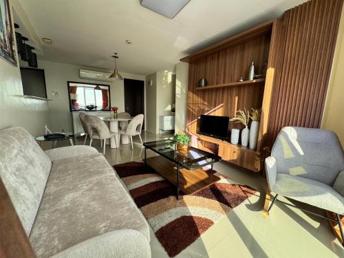 a living room with a couch and a table at 2-3Bedroom Unit at The Padgett Place Condominium in Tabok