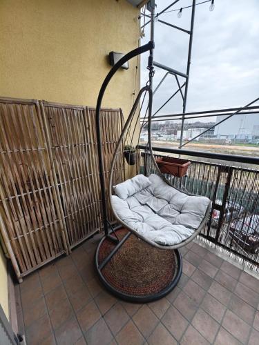 a swinging chair sitting on a balcony at Rogoredo - 10 min-Linate airport 100 m from the metro in Milan
