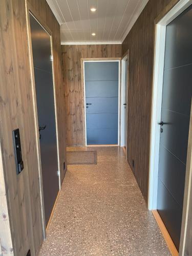 a hallway with two elevators and a door to a closet at Hytte med sjøutsikt in Bamble
