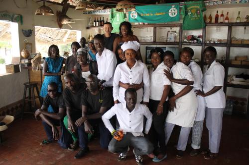 a group of people posing for a picture in a room at Hôtel Les Cordons Bleus in Ndangane
