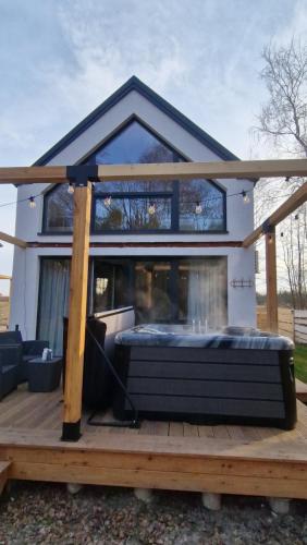 a house with a large deck with a fireplace at Chill Chaty in Tarnobrzeg