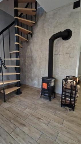 a stove in a room with a staircase at Chill Chaty in Tarnobrzeg