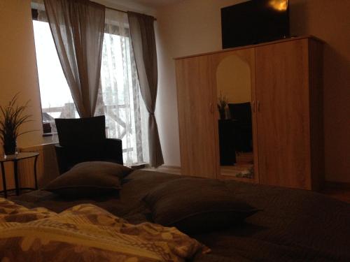 a bedroom with a bed and a large window at Gospodarstwo Rospuda in Bakałarzewo