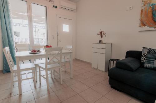 a living room with a table and chairs and a couch at Spyridoula's apartment in Nafplio
