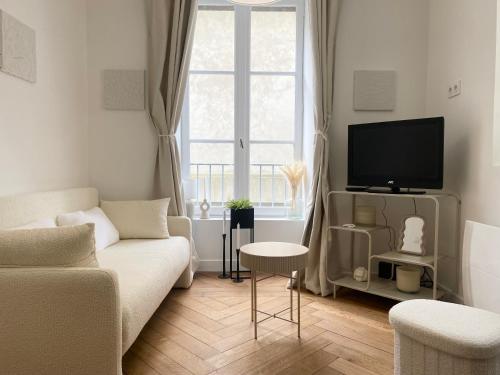 un salon avec un canapé et une télévision dans l'établissement Cocon cosy hyper centre, à Saint-Malo