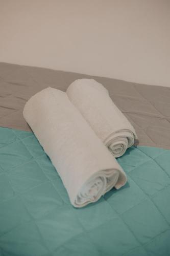two rolls of towels sitting on top of a floor at Spyridoula's apartment in Nafplio