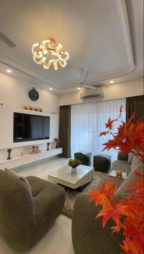 a living room with a couch and a tv at Cuddle Corner -Embrace Cuteness in North goa