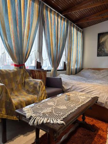 a living room with a bed and a couch and a coffee table at Kimon Penthouse in Thessaloniki