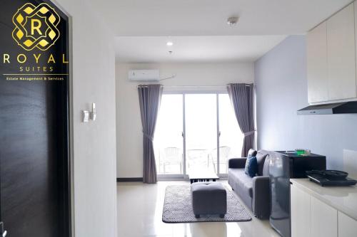 a living room with a couch and a window at Royal Suites 2BR 28RV - Citra Plaza Nagoya Apartment in Jodoh