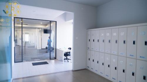 a room with lockers and a man standing in a hallway at Royal Suites 2BR 28RV - Citra Plaza Nagoya Apartment in Jodoh