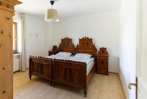 a bedroom with a large wooden bed in a room at Large apartment with panoramic view in Meluno