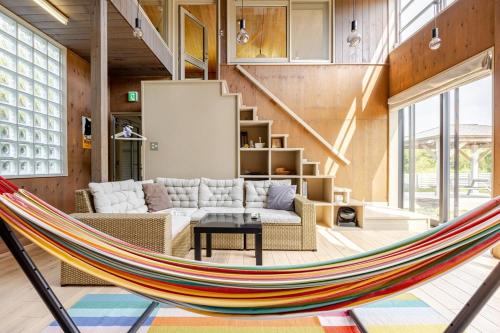 a hammock in the living room of a house at Sea and Gallery house館山 in Tateyama
