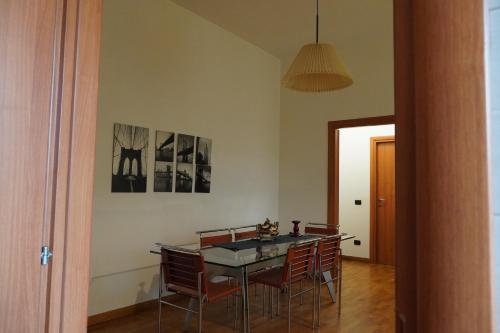 a dining room with a table and chairs at Roma 1 Apartment - THE V Collection in Turate