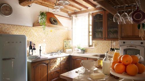 a kitchen with a bunch of oranges on a counter at Rustico Dora in Camaiore