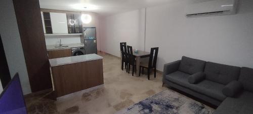 a living room with a couch and a kitchen at Sea View Ras El Hekma Rental Chalet in Jalāl