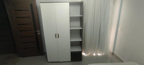 a white cabinet with lights in a room at Sea View Ras El Hekma Rental Chalet in Jalāl