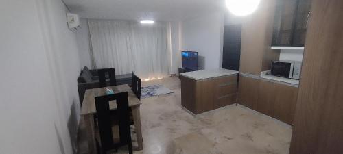 a small room with a kitchen and a microwave at Sea View Ras El Hekma Rental Chalet in Jalāl