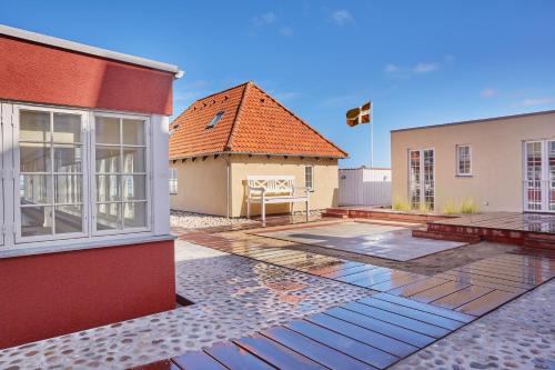 a house with a patio and a building at Hôtel de Ville in Gilleleje