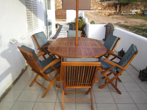 ein Holztisch und Stühle auf einer Terrasse in der Unterkunft Sa Tanca den Marines ETV 1272 E in Sant Carles de Peralta